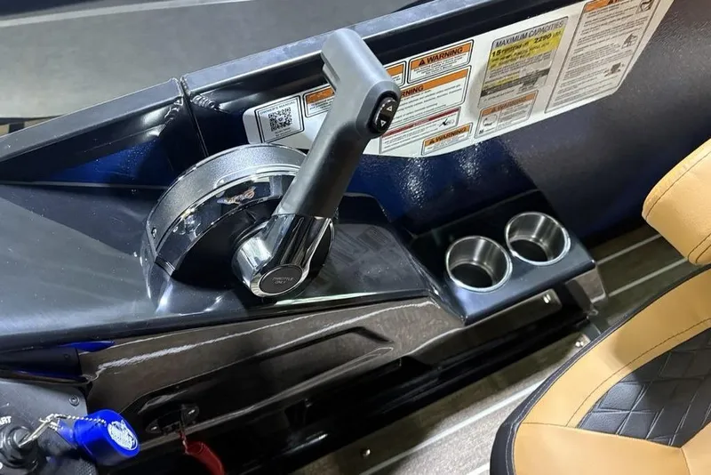 Slide: The Image of Control panel of 2026 Premier 230 Sunsation RL with throttle and cup holders. - 22