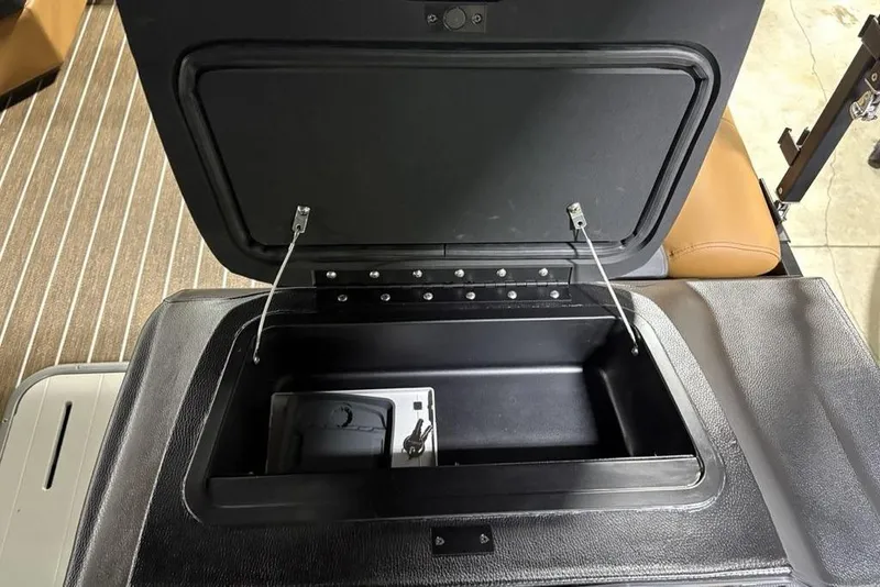 Slide: The Image of Open storage compartment in 2026 Premier 230 Sunsation RL boat, showcasing interior design. - 25