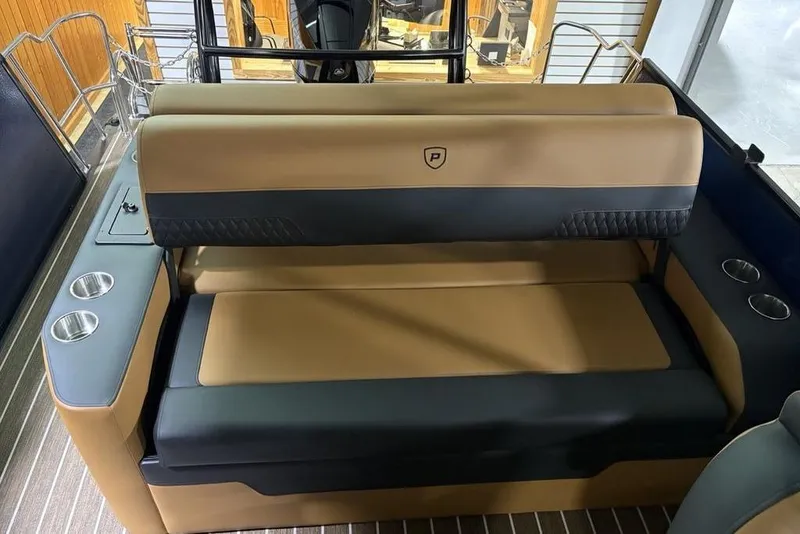 Slide: The Image of 2026 Premier 230 Sunsation RL boat interior with tan and black seating, cup holders. - 28