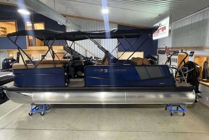 The Image of 2026 Premier 230 Sunsation RL pontoon boat displayed indoors with canopy. - 3