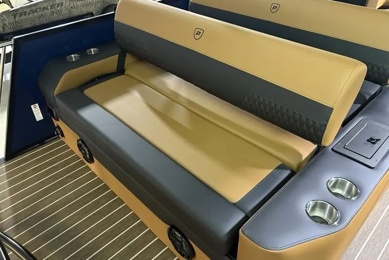 Slide: The Image of 2026 Premier 230 Sunsation RL boat interior with tan and gray seating, cup holders, and speakers. - 30