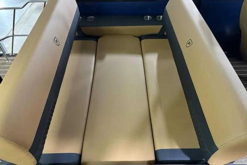 Slide: The Image of 2026 Premier 230 Sunsation RL boat seating, beige and navy upholstery, cup holders visible. - 32