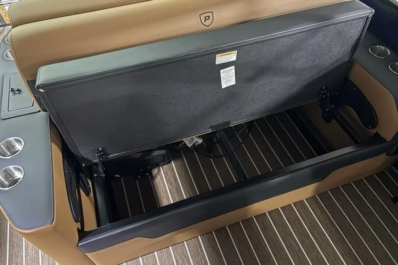 Slide: The Image of 2026 Premier 230 Sunsation RL boat interior with open storage compartment and cup holders. - 33