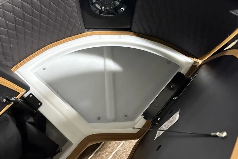 Slide: The Image of Interior view of 2026 Premier 230 Sunsation RL boat with quilted upholstery and wood accents. - 7