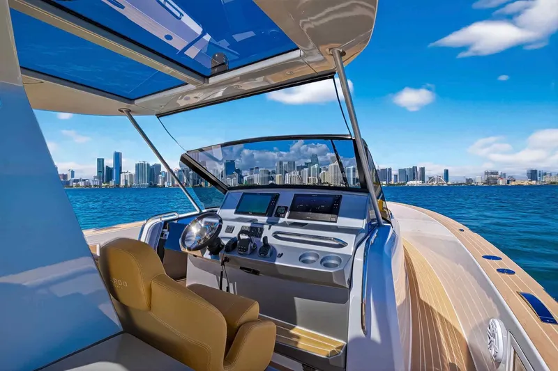Slide: The Image of 2023 Pardo Yachts 43 cockpit with city skyline view, featuring modern navigation equipment. - 22