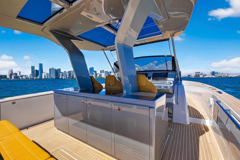 Slide: The Image of Luxurious 2023 Pardo Yachts 43 with sleek design, cruising near a vibrant city skyline. - 23