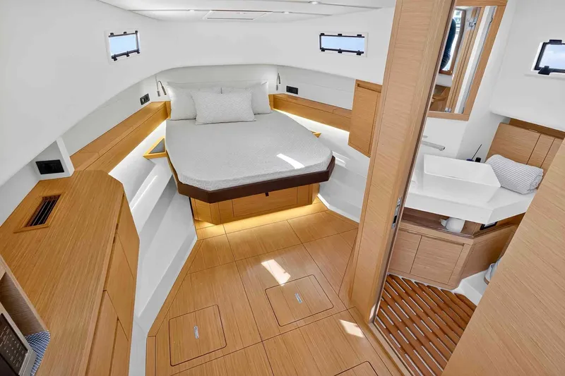 Slide: The Image of Luxurious interior of 2023 Pardo Yachts 43, featuring modern wood finishes and cozy bedding. - 37