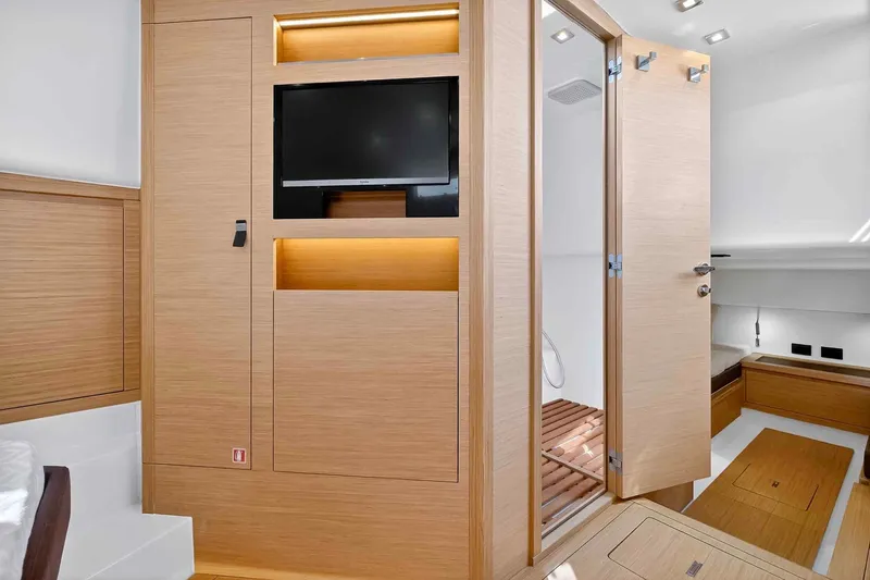 Slide: The Image of Luxurious interior of 2023 Pardo Yachts 43, featuring modern wood paneling and built-in TV. - 40