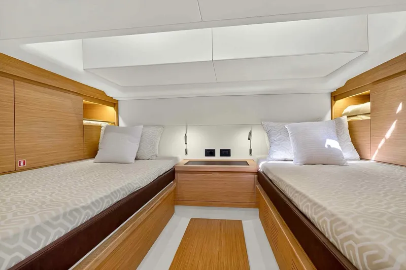 Slide: The Image of Luxurious interior of 2023 Pardo Yachts 43 with twin beds and modern wood finish. - 44