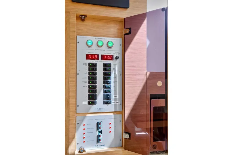 Slide: The Image of Electrical control panel on 2023 Pardo Yachts 43, featuring switches and digital displays. - 52