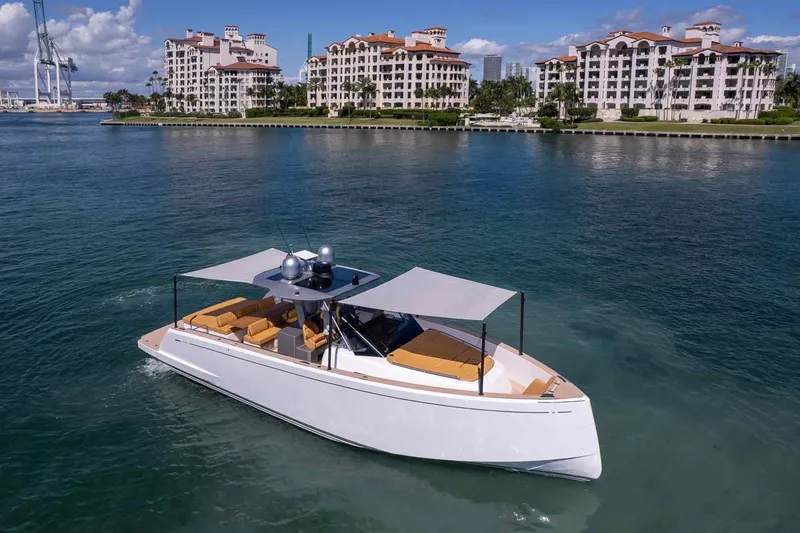 Slide: The Image of 2023 Pardo Yachts 43 cruising near luxury waterfront apartments. - 65