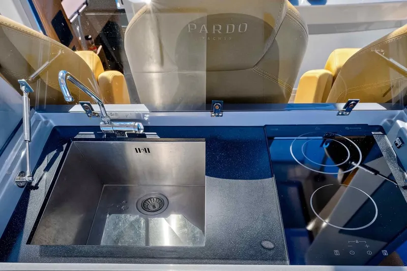 Slide: The Image of Modern kitchen area on 2023 Pardo Yachts 43, featuring sink and induction cooktop. - 21