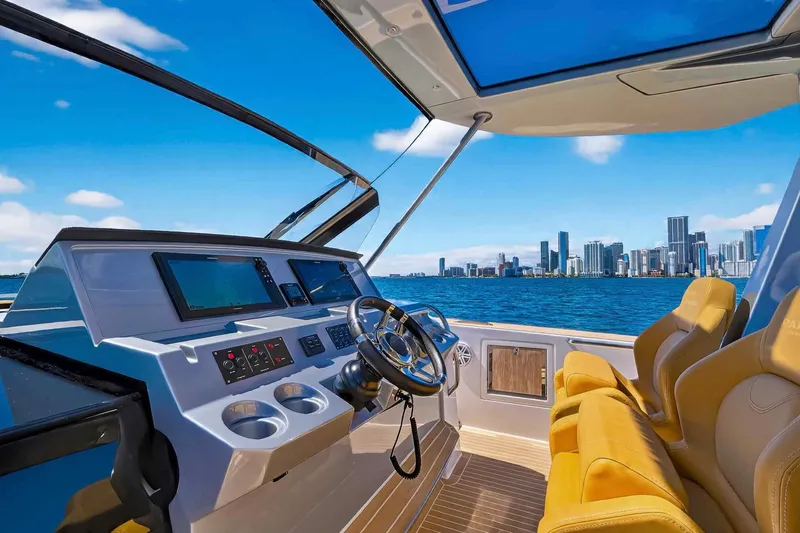 Slide: The Image of 2023 Pardo Yachts 43 helm with city skyline view, featuring luxurious seating and modern controls. - 24