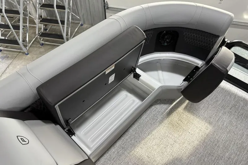 Slide: The Image of 2026 Premier 230 Solaris RF boat interior with open storage compartment and seating. - 14