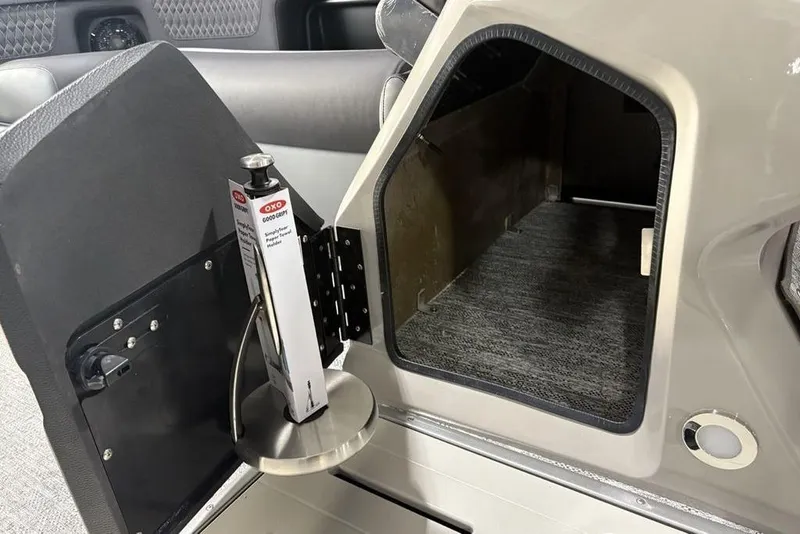 Slide: The Image of 2026 Premier 230 Solaris RF storage compartment with OXO tool holder. - 16