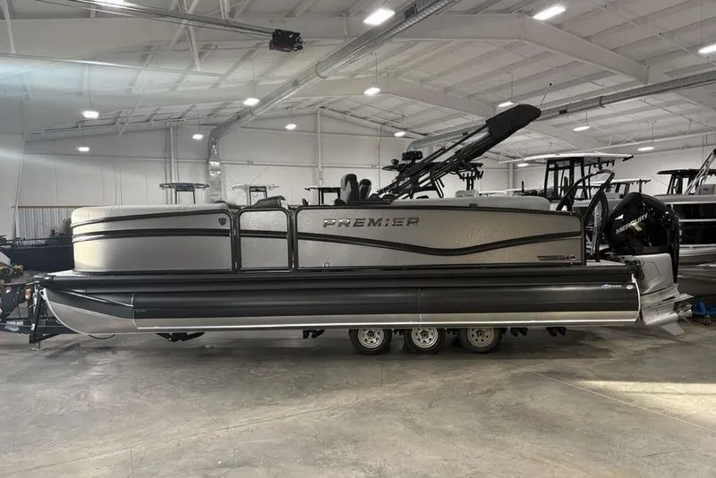The Image of 2026 Premier 230 Solaris RF pontoon boat in a spacious indoor showroom. - 2