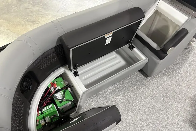 Slide: The Image of 2026 Premier 230 Solaris RF boat interior with open storage compartments and visible battery. - 32