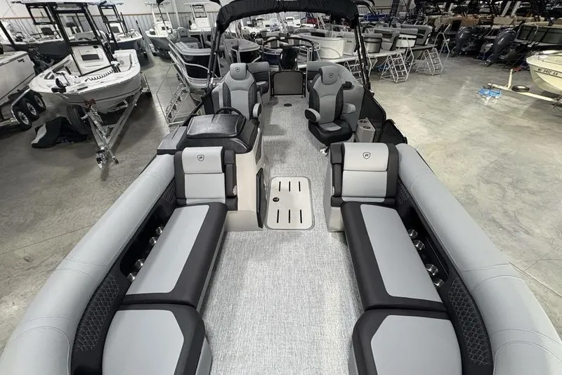 Slide: The Image of 2026 Premier 230 Solaris RF pontoon boat interior with luxurious seating in showroom. - 36