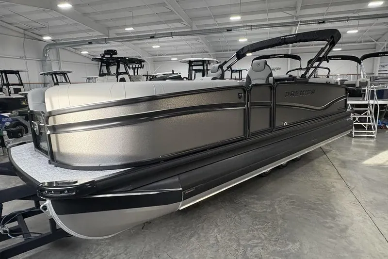 Slide: The Image of 2026 Premier 230 Solaris RF pontoon boat in showroom, featuring sleek design and modern amenities. - 5