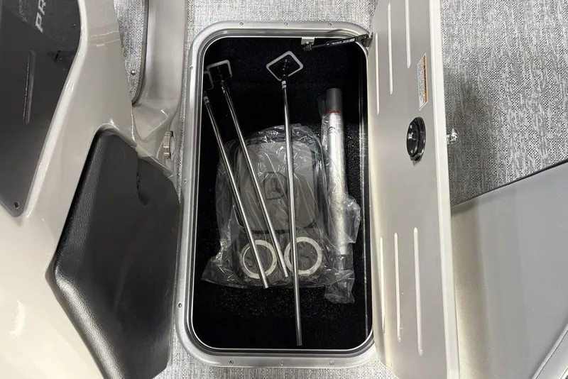 Slide: The Image of Storage compartment of 2026 Premier 230 Solaris RF boat with accessories inside. - 9