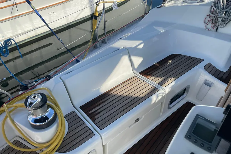 Slide: The Image of Cockpit of 2003 Jeanneau Sun Odyssey 43 DS with teak seating and winch. - 10