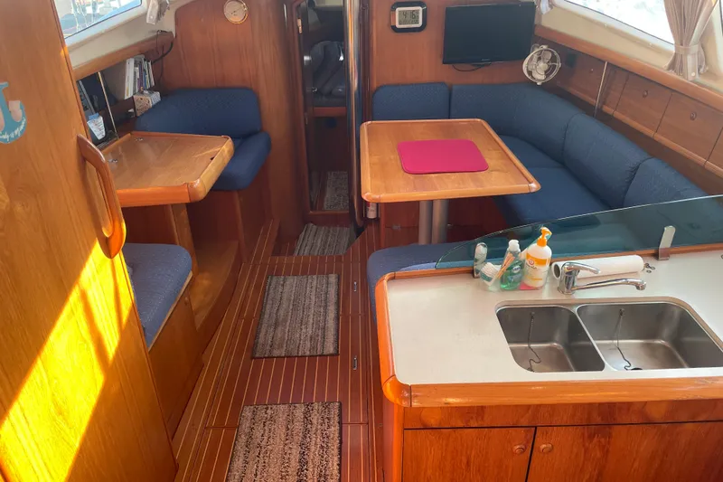 Slide: The Image of Interior of 2003 Jeanneau Sun Odyssey 43 DS sailboat with cozy seating and kitchenette. - 12