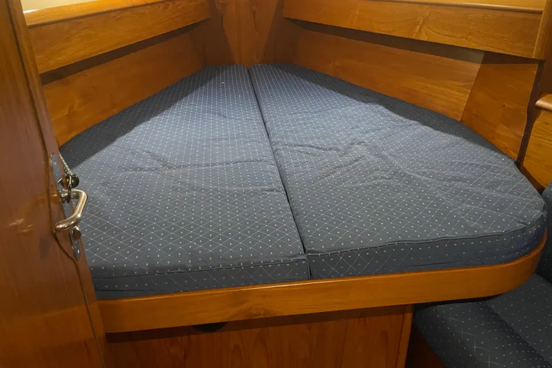 Slide: The Image of Cozy cabin bed in 2003 Jeanneau Sun Odyssey 43 DS sailboat, featuring blue patterned cushions. - 18