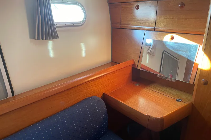 Slide: The Image of Cozy cabin interior of 2003 Jeanneau Sun Odyssey 43 DS with wooden desk and mirror. - 20