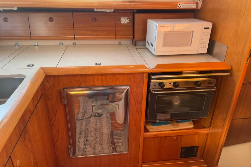 Slide: The Image of Jeanneau Sun Odyssey 43 DS 2003 yacht kitchen with microwave and oven. - 25