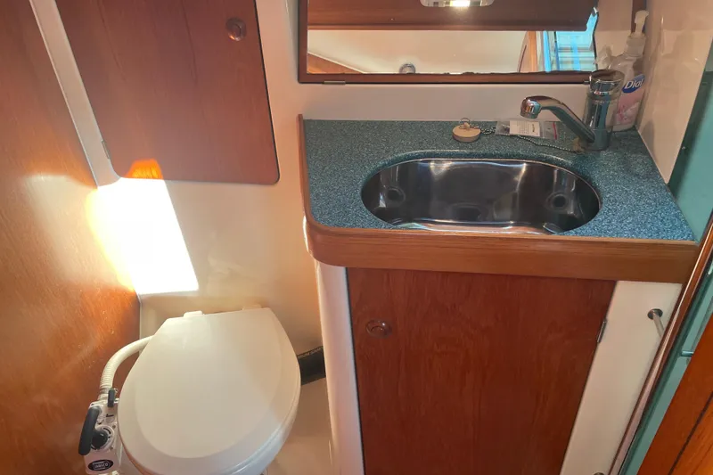 Slide: The Image of Bathroom interior of 2003 Jeanneau Sun Odyssey 43 DS yacht, featuring sink and toilet. - 35