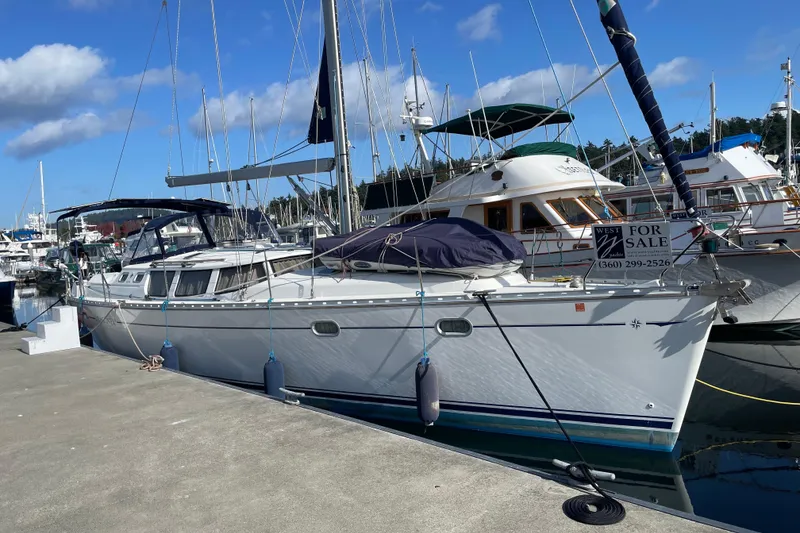 Slide: The Image of 2003 Jeanneau Sun Odyssey 43 DS sailboat docked, for sale sign visible. - 4