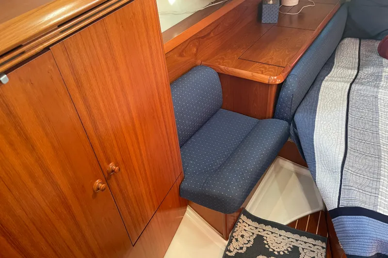Slide: The Image of Cozy cabin interior of 2003 Jeanneau Sun Odyssey 43 DS with wooden furniture and blue upholstery. - 41