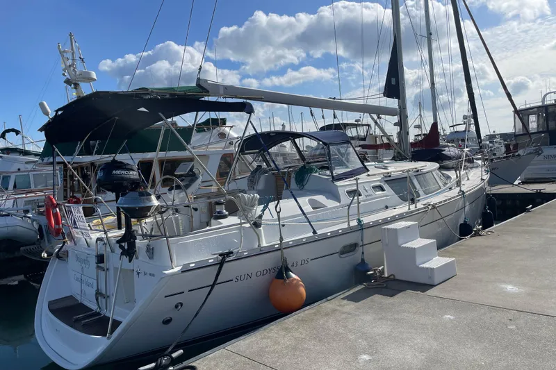 Slide: The Image of 2003 Jeanneau Sun Odyssey 43 DS sailboat docked at marina under blue sky. - 5