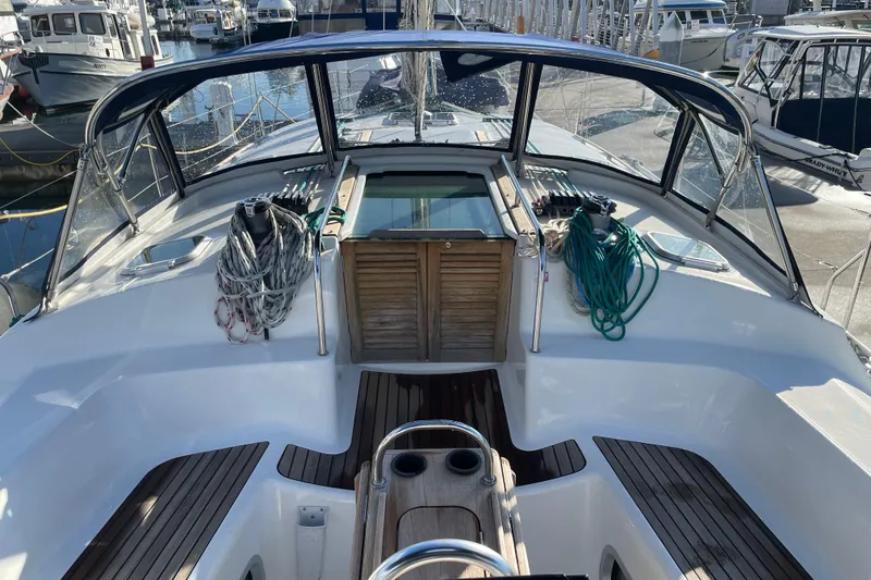 Slide: The Image of 2003 Jeanneau Sun Odyssey 43 DS sailboat cockpit with ropes and wooden accents in marina. - 7