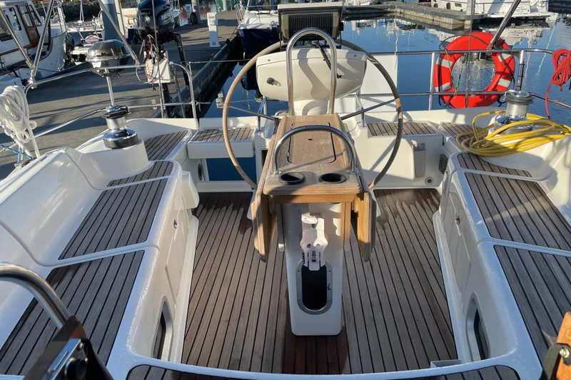 Slide: The Image of Cockpit of 2003 Jeanneau Sun Odyssey 43 DS sailboat with wooden deck and steering wheel. - 8