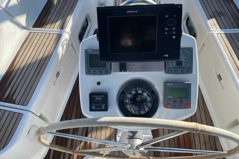 Slide: The Image of Steering console of 2003 Jeanneau Sun Odyssey 43 DS with navigation instruments. - 9