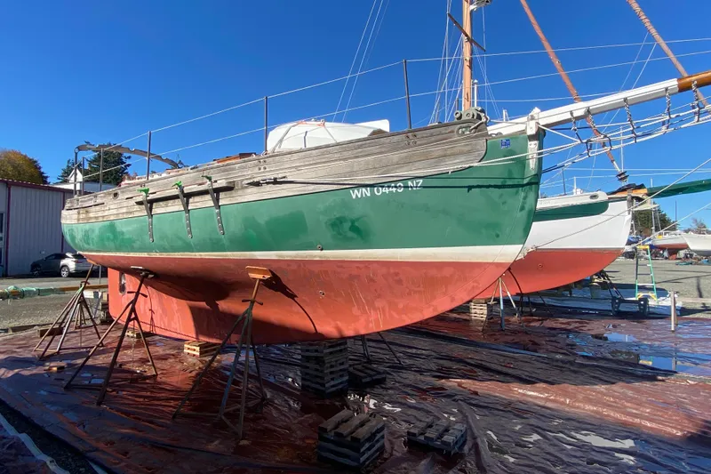 The Image of 1978 Bristol Channel Cutter 28 sailboat on stands, green hull, dry docked for maintenance. - 0