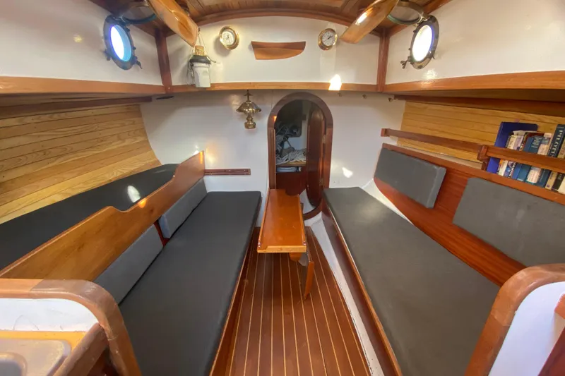 Slide: The Image of Interior of a 1978 Bristol Channel Cutter 28 sailboat with wooden accents and seating. - 17