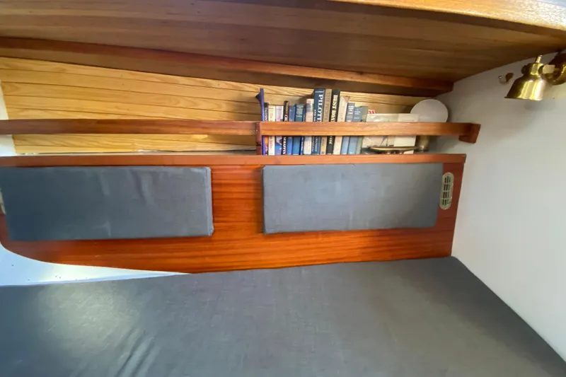 Slide: The Image of Cozy interior of 1978 Bristol Channel Cutter 28 with books and wooden shelves. - 19