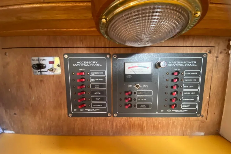 Slide: The Image of Control panels on a 1978 Bristol Channel Cutter 28, featuring accessory and master power switches. - 27