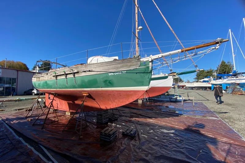 Slide: The Image of 1978 Bristol Channel Cutter 28 sailboat on dry dock under clear blue sky. - 3