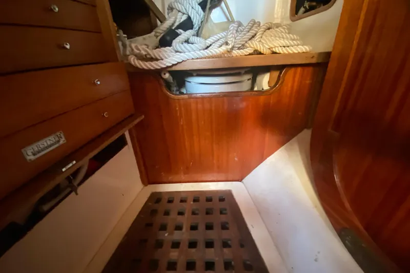 Slide: The Image of Interior of 1978 Bristol Channel Cutter 28 with wooden cabinetry and coiled ropes. - 32