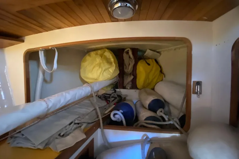 Slide: The Image of Interior storage of 1978 Bristol Channel Cutter 28 with sails and equipment. - 34