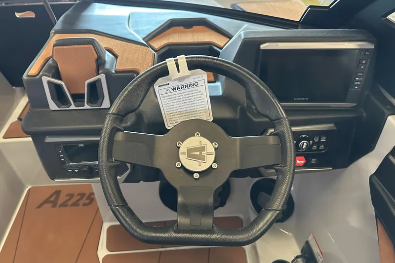 Slide: The Image of Steering wheel and dashboard of 2026 Axis A225 boat with Garmin display. - 4
