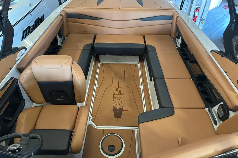 Slide: The Image of 2026 Axis A225 boat interior with tan and black seating, featuring a stylish deck design. - 6