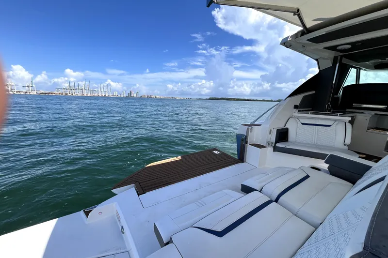 Slide: The Image of 2021 Tiara Yachts 43 LE on open water, featuring luxurious seating and scenic ocean view. - 20