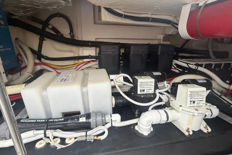 Slide: The Image of Engine compartment of 2021 Tiara Yachts 43 LE, showcasing pumps and wiring. - 29