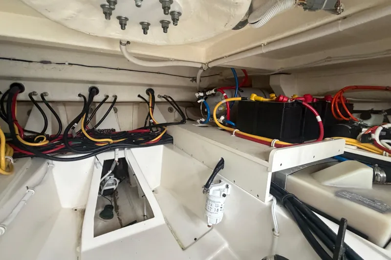 Slide: The Image of Engine compartment of 2021 Tiara Yachts 43 LE, showcasing wiring and battery setup. - 30
