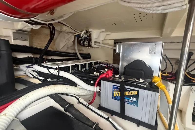 Slide: The Image of Engine compartment of 2021 Tiara Yachts 43 LE with battery and wiring. - 32