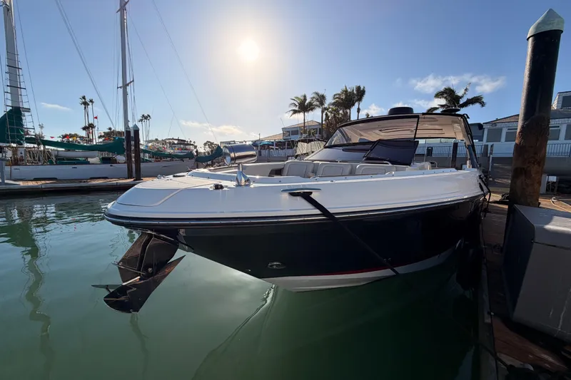Slide: The Image of 2021 Sea Ray SLX 400 boat docked in a sunny marina setting. - 10
